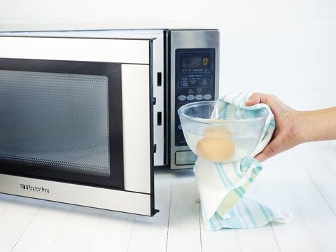 Eggs being placed in a microwave