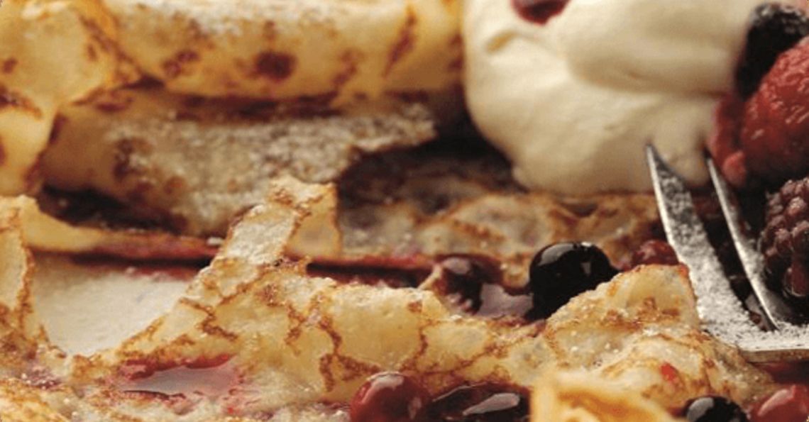 Lacy pancakes served with rosewater berries