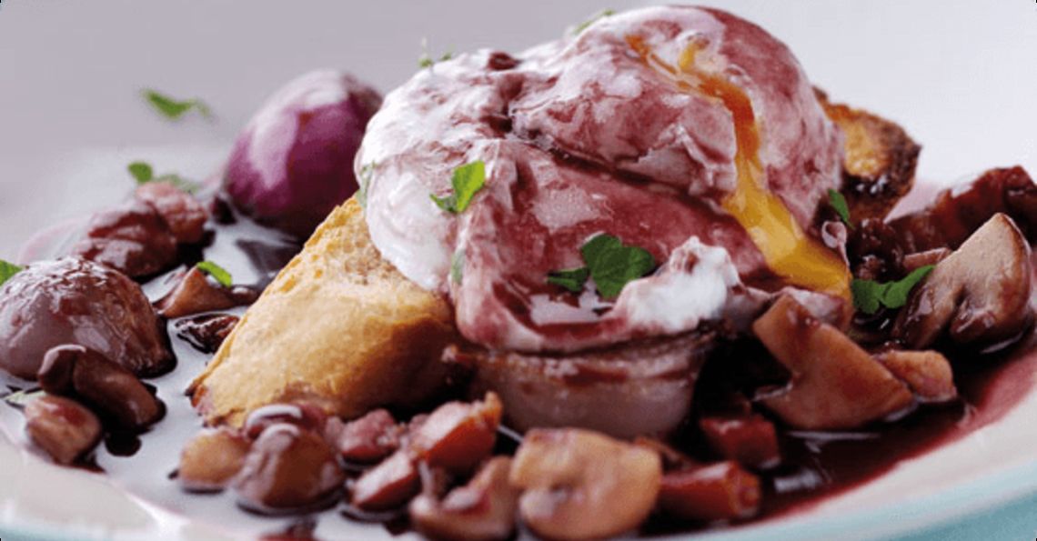 Poached eggs in red wine with smoked bacon and onions