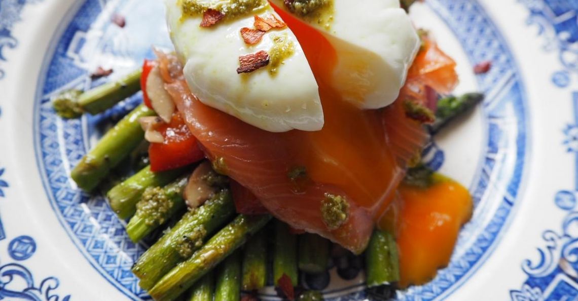 Eggs, asparagus & salmon stack with a pesto drizzle