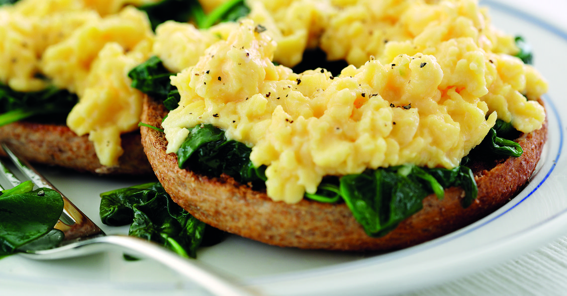 Toasted bagel with spinach and eggs