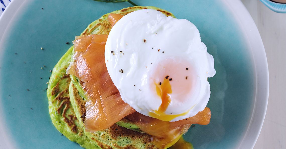 Spinach and dill pancakes with salmon and eggs