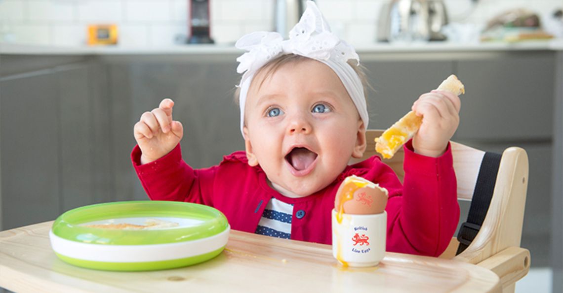 baby enjoying a runny British Lion egg at home