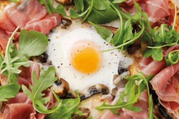 Baked egg pizza with portabella mushroom and cured ham