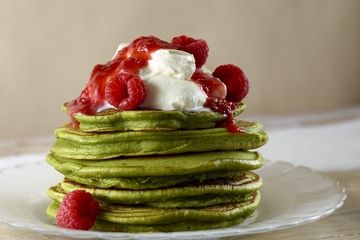 Super green matcha pancakes, coconut cream and raspberries