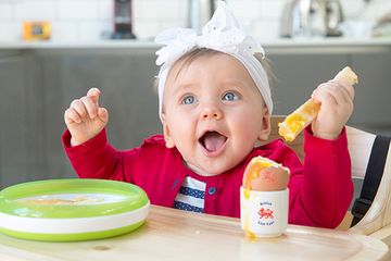 baby enjoying a runny British Lion egg at home